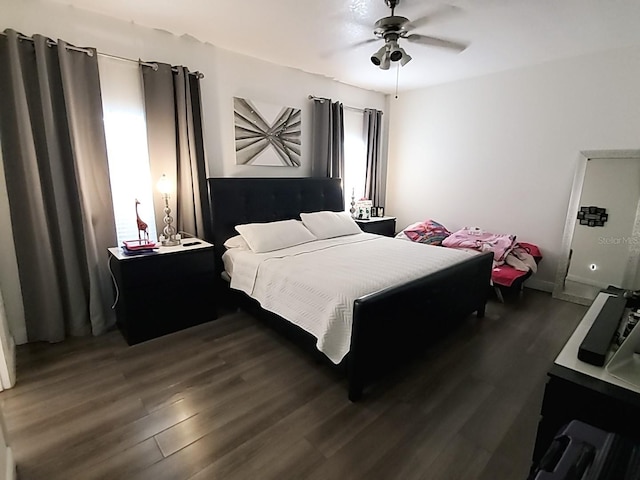 bedroom with ceiling fan and dark hardwood / wood-style flooring