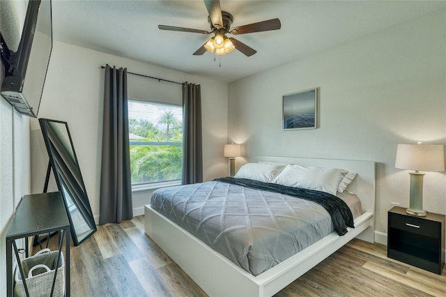 bedroom with ceiling fan and light hardwood / wood-style floors