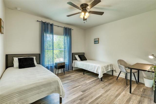 bedroom with ceiling fan and light hardwood / wood-style flooring