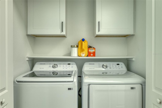 washroom with separate washer and dryer and cabinets