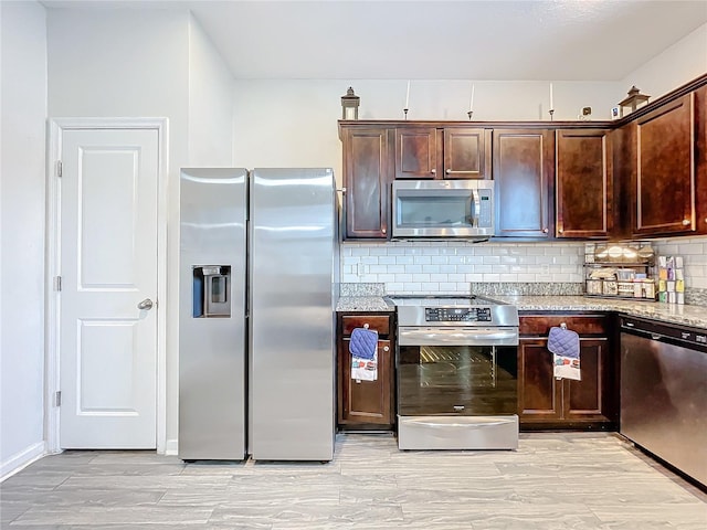 kitchen featuring light stone counters, appliances with stainless steel finishes, backsplash, and dark brown cabinetry