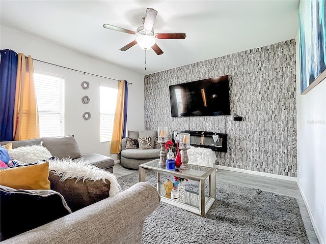 living room featuring wood-type flooring and ceiling fan