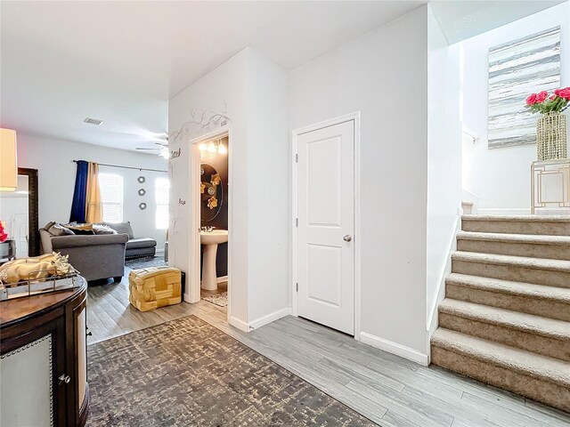 corridor featuring hardwood / wood-style floors and sink