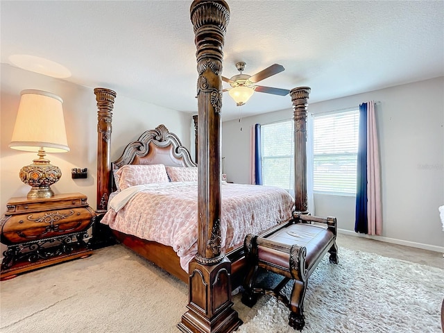 carpeted bedroom featuring ceiling fan and a textured ceiling