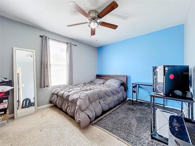 bedroom with a textured ceiling, carpet flooring, and ceiling fan