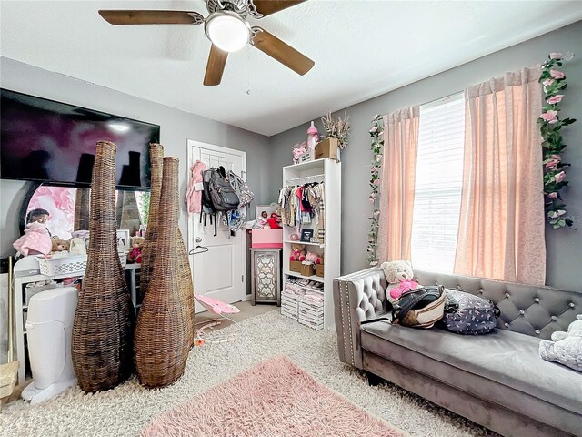 carpeted bedroom with a closet and ceiling fan