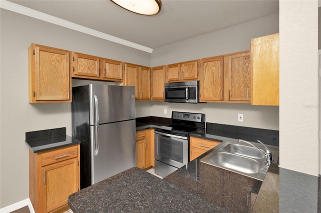 kitchen featuring kitchen peninsula, ornamental molding, sink, and appliances with stainless steel finishes