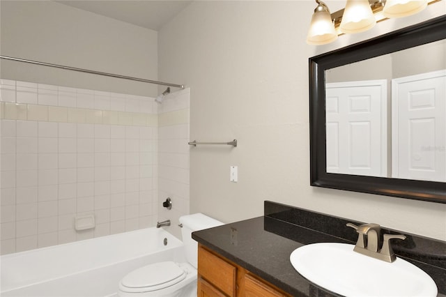 full bathroom featuring vanity, tiled shower / bath combo, and toilet