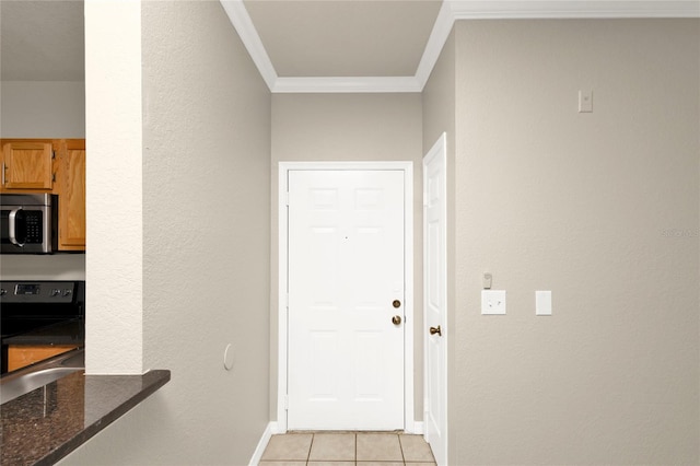 doorway to outside with light tile patterned floors and crown molding