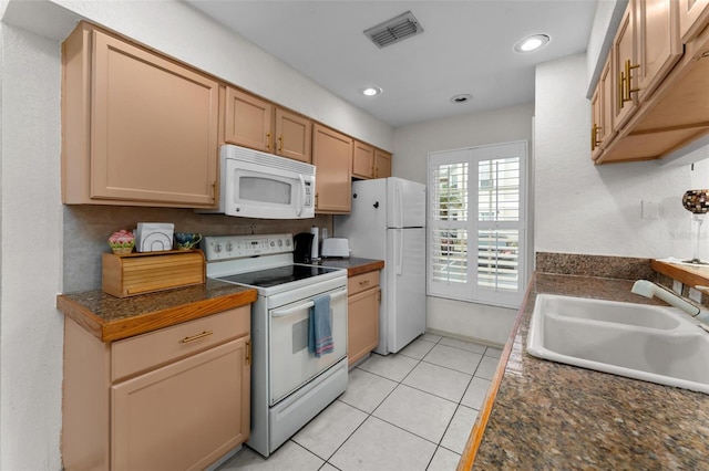 kitchen featuring sink, decorative backsplash, white appliances, light tile patterned floors, and light brown cabinetry