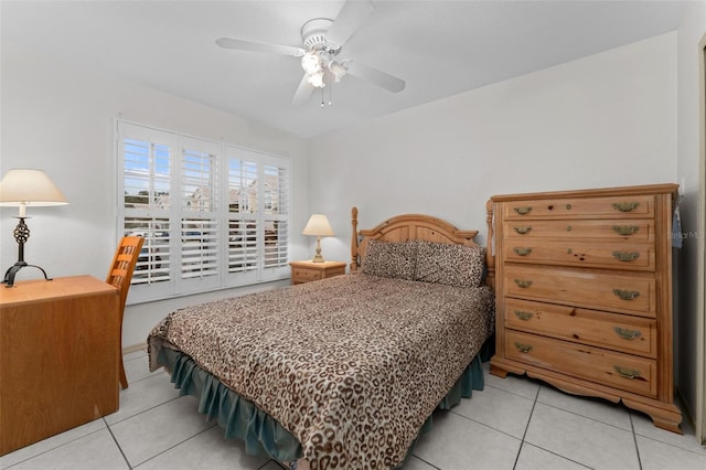 tiled bedroom featuring ceiling fan