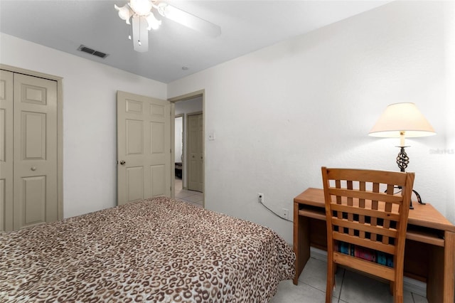 tiled bedroom with a closet and ceiling fan