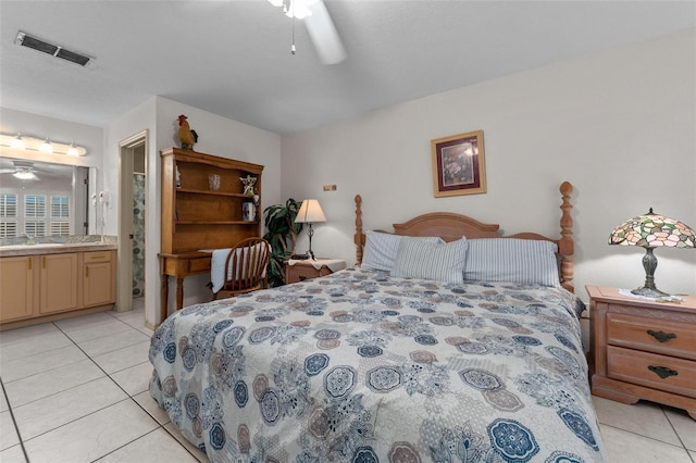 tiled bedroom featuring connected bathroom, ceiling fan, and sink