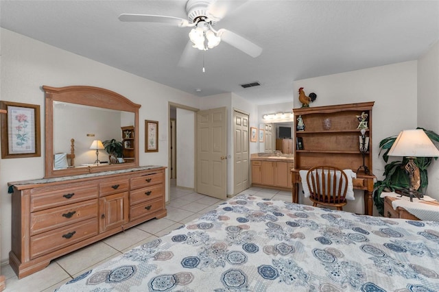 tiled bedroom with ceiling fan and connected bathroom