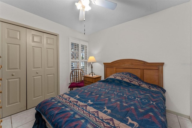 bedroom with a closet, ceiling fan, and light tile patterned flooring