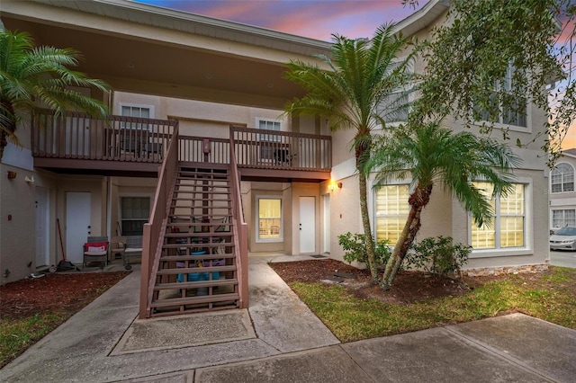 exterior entry at dusk featuring a patio