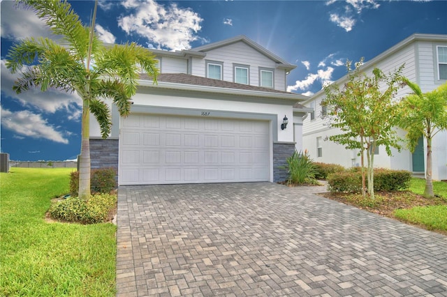 view of front facade with a garage and a front lawn