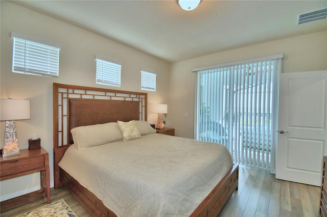 bedroom featuring hardwood / wood-style floors and access to exterior