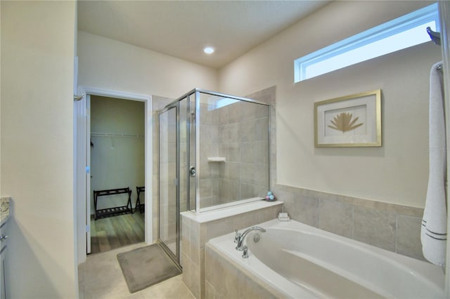 bathroom featuring shower with separate bathtub and vanity