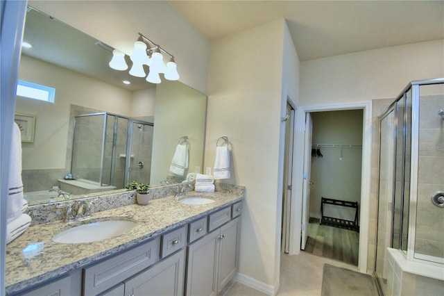 bathroom with vanity and a shower with door