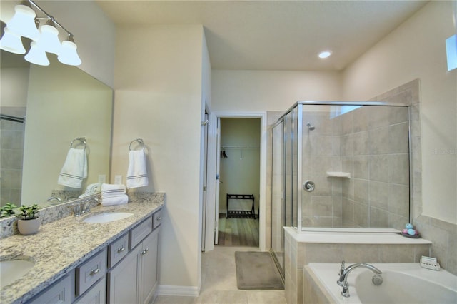 bathroom featuring tile patterned flooring, vanity, and separate shower and tub