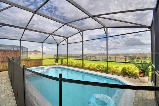 view of swimming pool with a lawn, a lanai, and a patio area