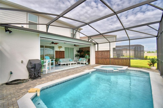 view of pool with a patio, an in ground hot tub, a lanai, outdoor lounge area, and ceiling fan