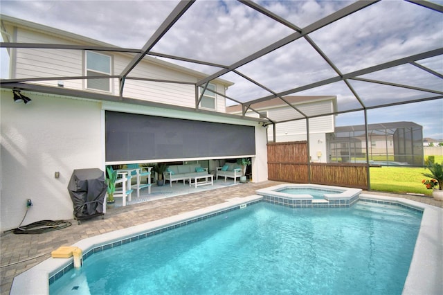 view of pool with a patio, an in ground hot tub, area for grilling, and a lanai