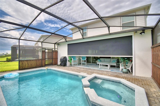 view of pool featuring an in ground hot tub, glass enclosure, and a patio