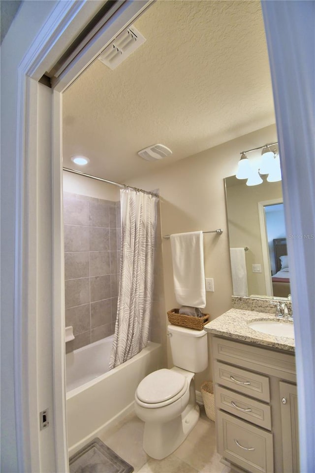 full bathroom with tile patterned flooring, a textured ceiling, shower / bathtub combination with curtain, vanity, and toilet