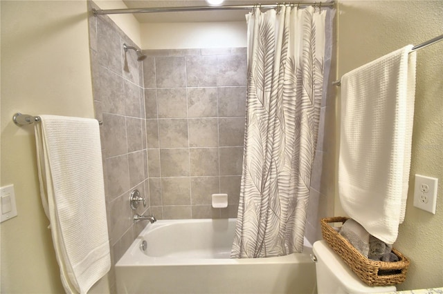 bathroom with shower / bath combo with shower curtain and toilet