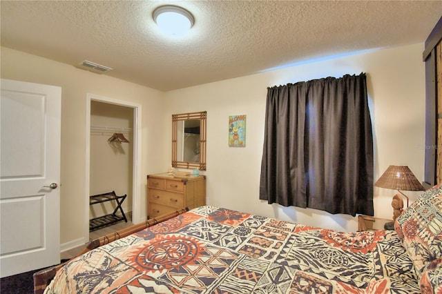 bedroom featuring a closet and a textured ceiling