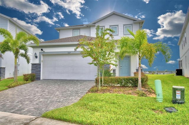 view of front of property featuring a front yard and a garage