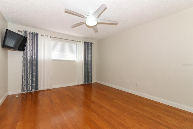 spare room with ceiling fan, hardwood / wood-style floors, and a textured ceiling