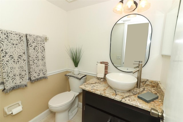 bathroom featuring tile patterned floors, vanity, and toilet