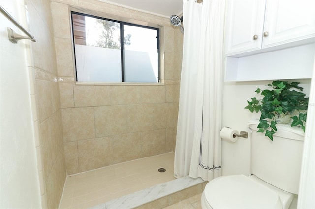 bathroom featuring toilet, tile patterned flooring, and a shower with shower curtain