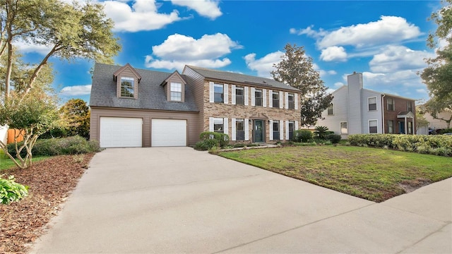 7972 Snowberry Cir, Orlando, FL 32819 - colonial home featuring driveway, an attached garage, and a front lawn