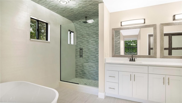 bathroom featuring shower with separate bathtub, tile patterned flooring, and vanity