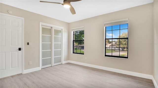 unfurnished room featuring light wood-type flooring and ceiling fan