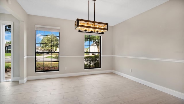 unfurnished dining area with a notable chandelier