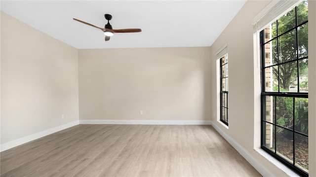 unfurnished room featuring light hardwood / wood-style floors, plenty of natural light, and ceiling fan