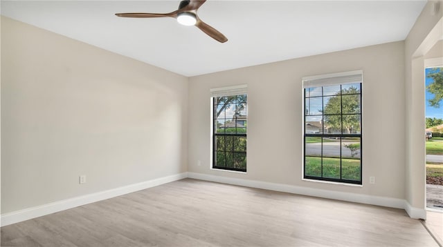 empty room featuring light wood-type flooring and ceiling fan