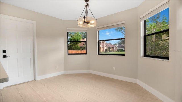 spare room with an inviting chandelier