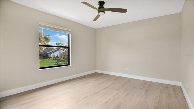 7972 Snowberry Cir, Orlando, FL 32819 - unfurnished room featuring light wood finished floors, ceiling fan, and baseboards