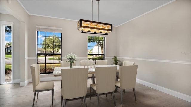 7972 Snowberry Cir, Orlando, FL 32819 - dining room featuring baseboards, crown molding, and plenty of natural light