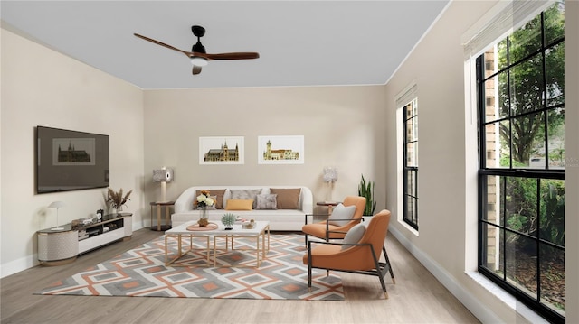 7972 Snowberry Cir, Orlando, FL 32819 - living room with wood finished floors, ceiling fan, and baseboards