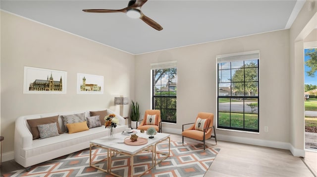 7972 Snowberry Cir, Orlando, FL 32819 - living area featuring wood finished floors, a ceiling fan, and baseboards