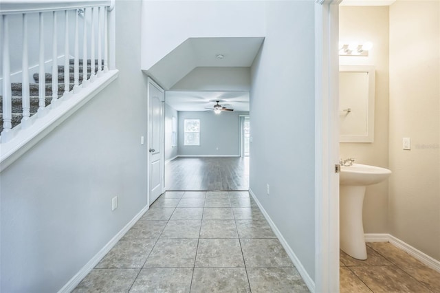 hallway with sink and light tile patterned floors