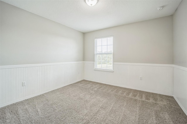 empty room with a textured ceiling and carpet