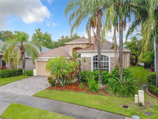 view of front of property with a garage and a front lawn